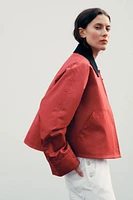 VESTE CIRÉE À COL EN MATIÈRES VARIÉES
