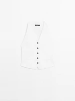 Veste sans manches en maille boutons contrastants