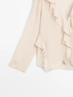 Ruffled blouse with asymmetric hem