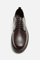 CHAUSSURES EN CUIR HABILLÉES