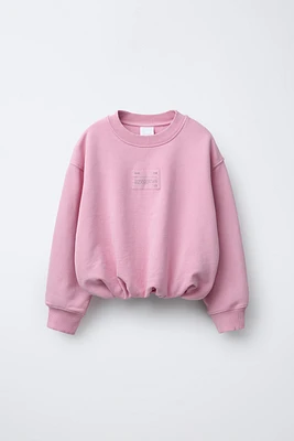 LABEL DETAIL BALLOON-HEM CROPPED SWEATSHIRT