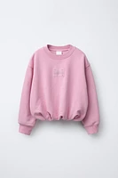 LABEL DETAIL BALLOON-HEM CROPPED SWEATSHIRT