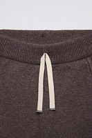 Jogger pants with elastic waistband and Front adjustable drawstring. pockets. Cuffed hems.