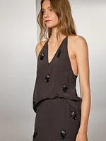 Flowing trousers with floral appliqués