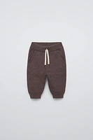 Jogger pants with elastic waistband and Front adjustable drawstring. pockets. Cuffed hems.