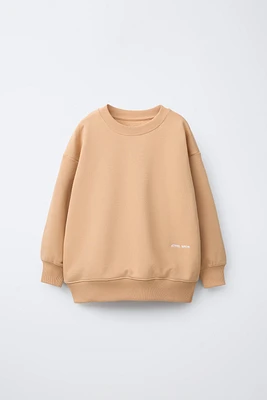 SWEAT UNI À INSCRIPTION BRODÉE