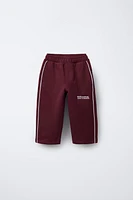 STRAIGHT PLUSH TEXT PANTS