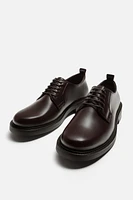 CHAUSSURES EN CUIR HABILLÉES