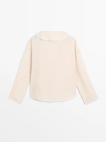 Ruffled blouse with asymmetric hem