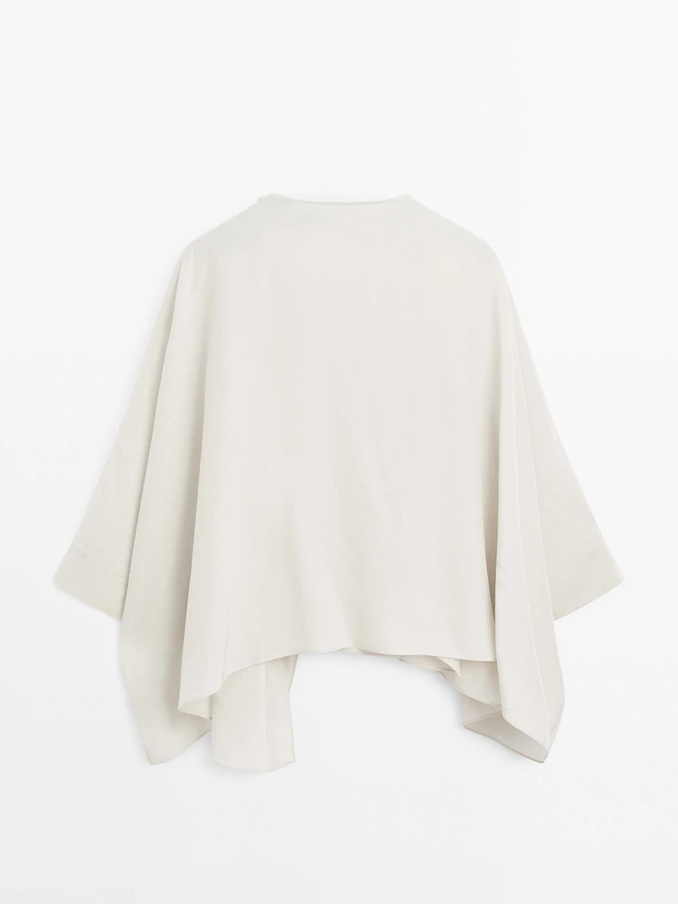 Short flowing cape with sleeve detail