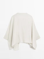 Short flowing cape with sleeve detail