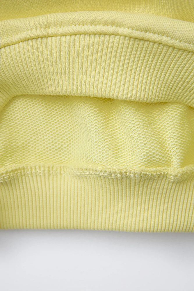 RAISED TEXT SWEATSHIRT