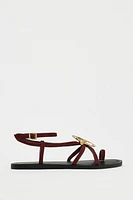 FLAT SUEDE SANDALS WITH METALLIC PIECE