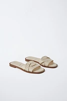 STUDDED CROSSOVER FLAT SANDALS