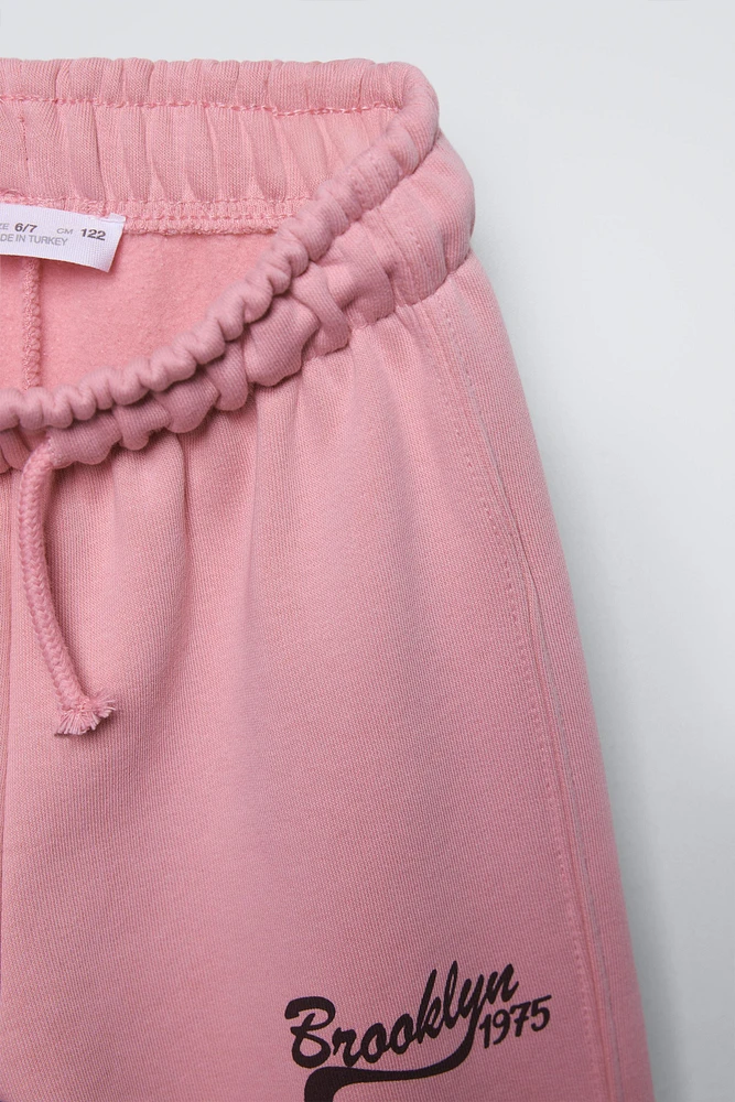 PANTALON À JAMBES LARGES EN MOLLETON AVEC INSCRIPTION