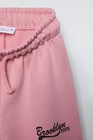PANTALON À JAMBES LARGES EN MOLLETON AVEC INSCRIPTION