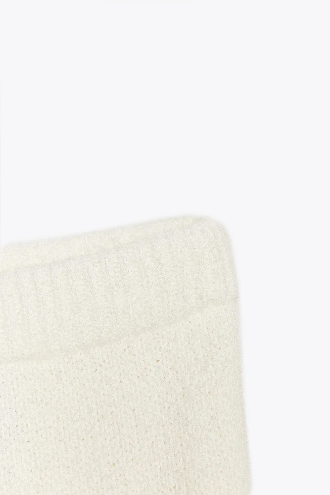 MINI JUPE EN MAILLE À SURPIQÛRES