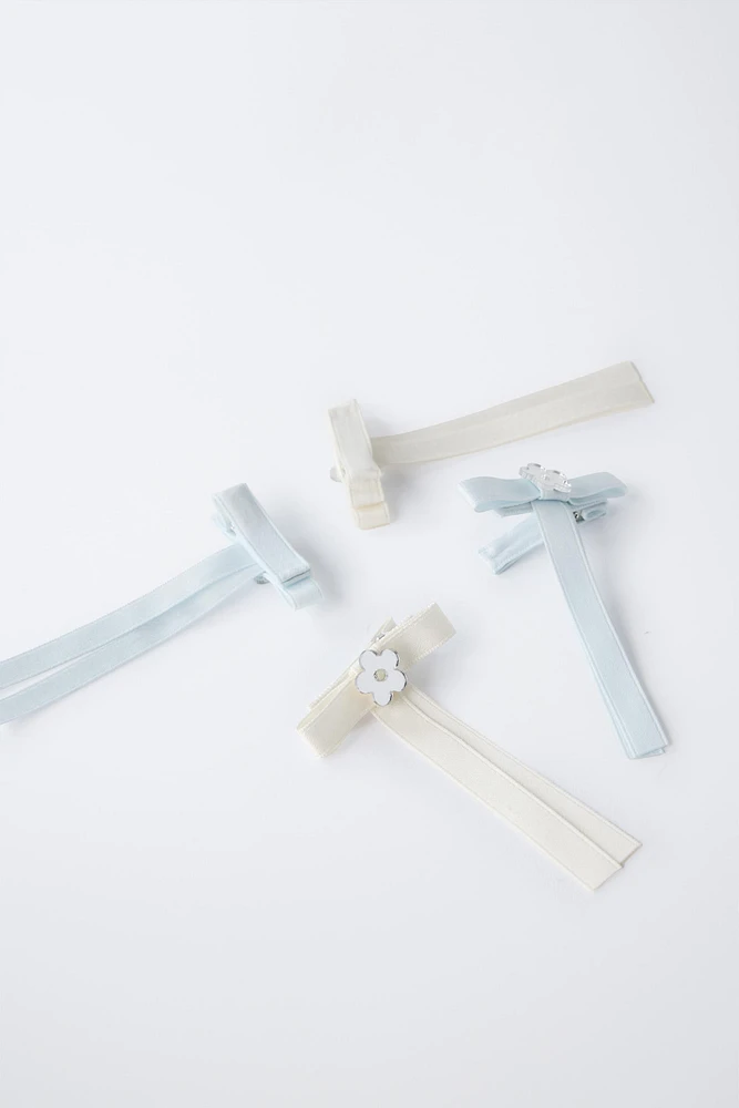 PACK OF FOUR BOW HAIR CLIPS WITH FLOWER