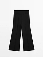 Flared trousers with zip