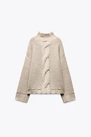 PULL EN MAILLE À TORSADES