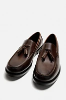 MOCASSINS CHICS À POMPONS