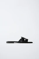 STUDDED CROSSOVER FLAT SANDALS