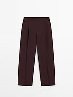 Flowing trousers with darts and thin waistband