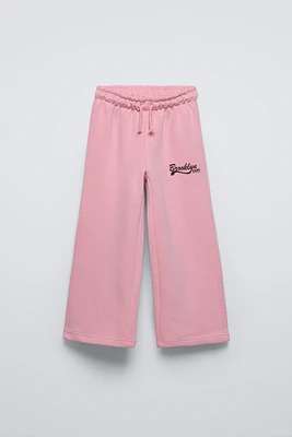 PANTALON À JAMBES LARGES EN MOLLETON AVEC INSCRIPTION