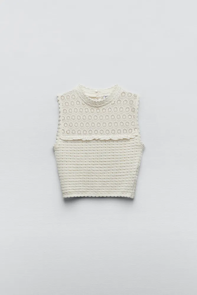 KNIT TOP WITH EMBROIDERED EYELET