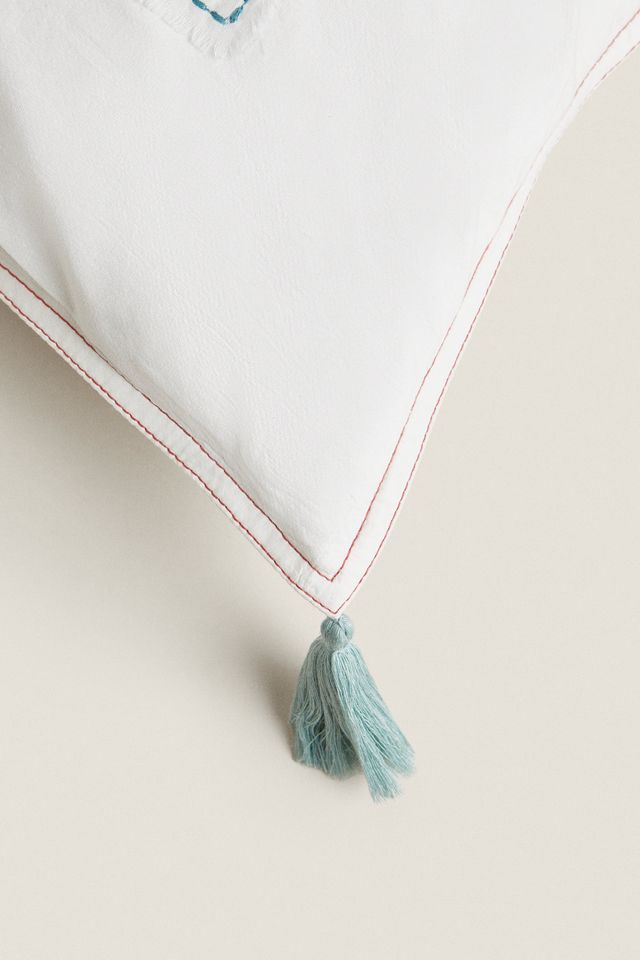 EMBROIDERED THROW PILLOW WITH TASSELS