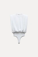 HEAVY COTTON RIB SHOULDER PAD BODYSUIT