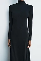 Midi turtleneck dress with long sleeves. A-line silhouette.