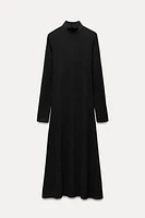 Midi turtleneck dress with long sleeves. A-line silhouette.