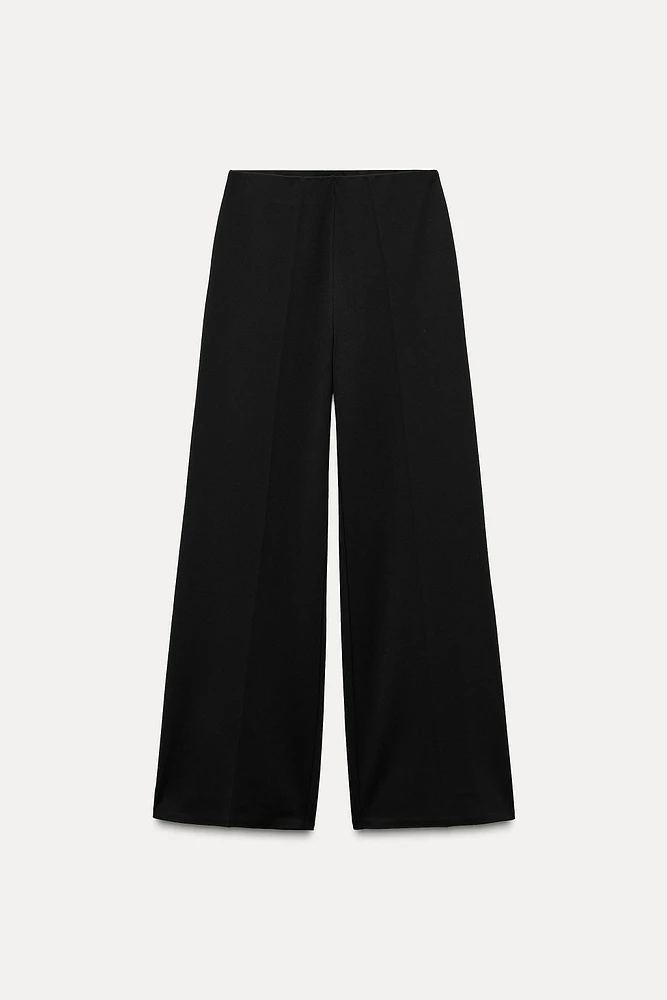 Wide leg pants with a high waist. Hidden zip closure at side.