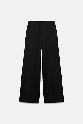 Wide leg pants with a high waist. Hidden zip closure at side.