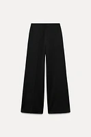 Wide leg pants with a high waist. Hidden zip closure at side.