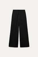 Wide leg pants with a high waist. Hidden zip closure at side.