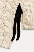 CABLE KNIT SWEATER WITH SIDE STRAPS