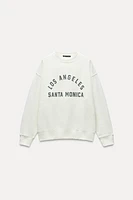 WASHED EFFECT RUBBERIZED TEXT SWEATSHIRT