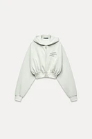 WASHED EFFECT HOODED CROP TEXT SWEATSHIRT