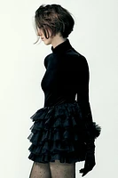 Mini skirt with a mid elastic waistband. Tulle ruffle details. Matching interior lining.<br/><br/>Halloween special collection.