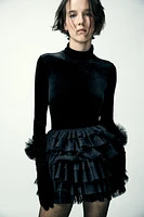 Mini skirt with a mid elastic waistband. Tulle ruffle details. Matching interior lining.<br/><br/>Halloween special collection.