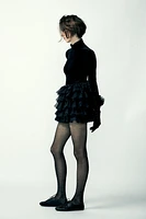 Mini skirt with a mid elastic waistband. Tulle ruffle details. Matching interior lining.<br/><br/>Halloween special collection.