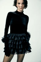 Mini skirt with a mid elastic waistband. Tulle ruffle details. Matching interior lining.<br/><br/>Halloween special collection.