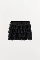 Mini skirt with a mid elastic waistband. Tulle ruffle details. Matching interior lining.<br/><br/>Halloween special collection.