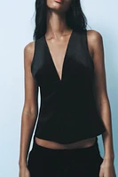 Sleeveless V-neck top. Interior lining. Front metal hook closure.