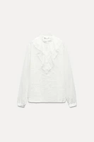 ZARA WOMAN COLLECTION<br/><br/>Blouse made with cotton. Round neck and long sleeves. Self ruffle detail. Front button closure.