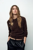 FAUX FUR KNIT SWEATER WITH BROOCHES