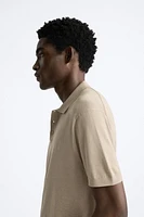 Cotton and silk blend polo shirt. Lapel collar with front button closure short sleeves. Rib trim.