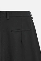 Wide fit pants. Front pleats at waist. Side pockets and back welt pockets. zip hidden metal hook closure.